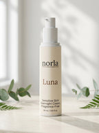 Luna Sensitive Skin Overnight Cream 50 ml by Norla, airless pump bottle on a marble surface with eucalyptus and fern