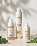 Norla Full Ritual Peptide Trio: Vera peptide serum, Ada AM/PM cream and Nellie eye cream on a marble surface with eucalyptus and fern
